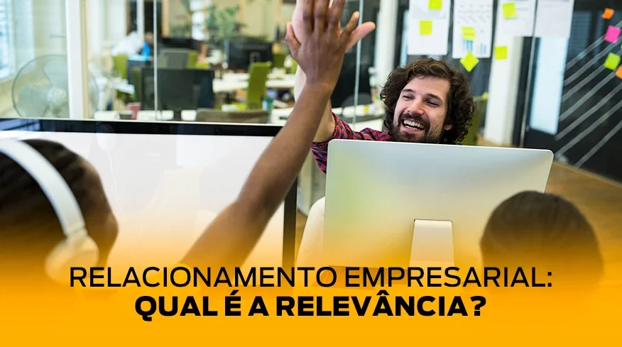 Dois colaboradores se cumprimentando e sorrindo em um bom relacionamento empresarial.